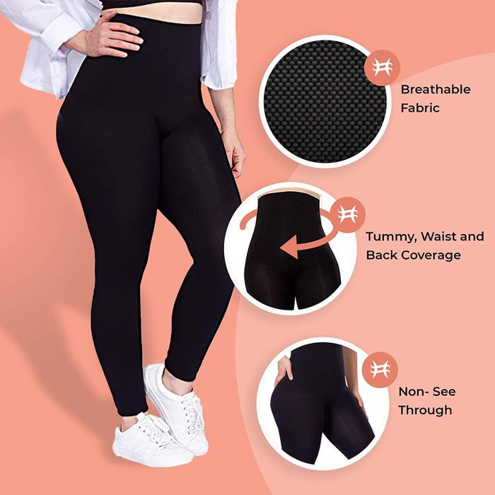 A girl posing in a black sports bra and black leggings
