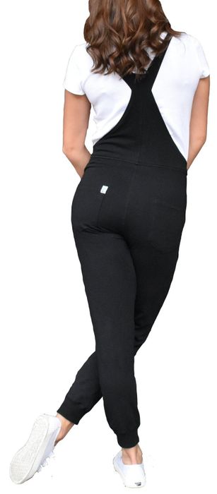 A model dressed in black overalls