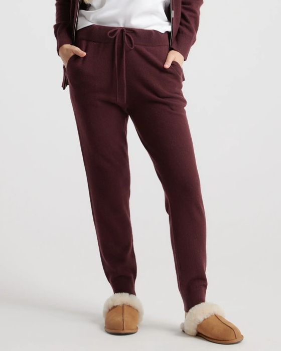 model showcasing the red sweatpants