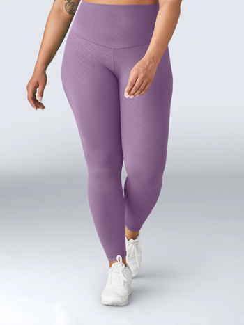 A model wearing high-waisted purple leggings