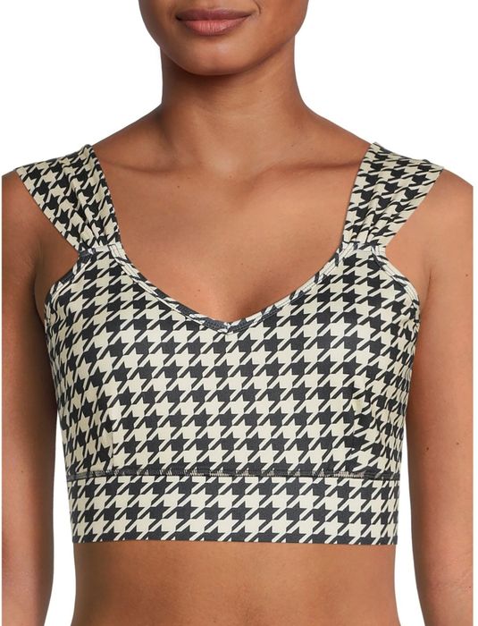 Model wearing a printed sports bra with ruched straps