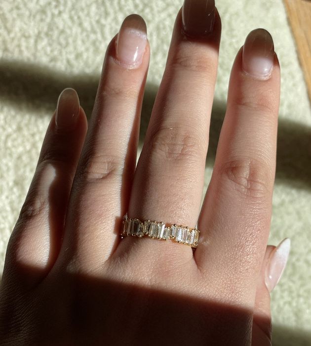 A reviewer is wearing a stunning ring.