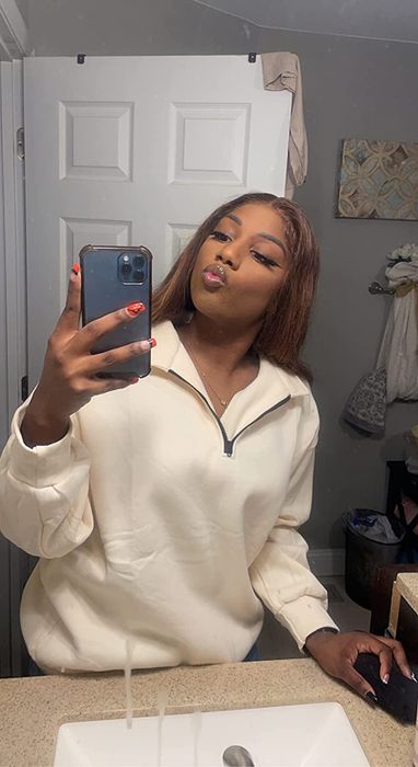 a reviewer showcasing the ivory sweatshirt