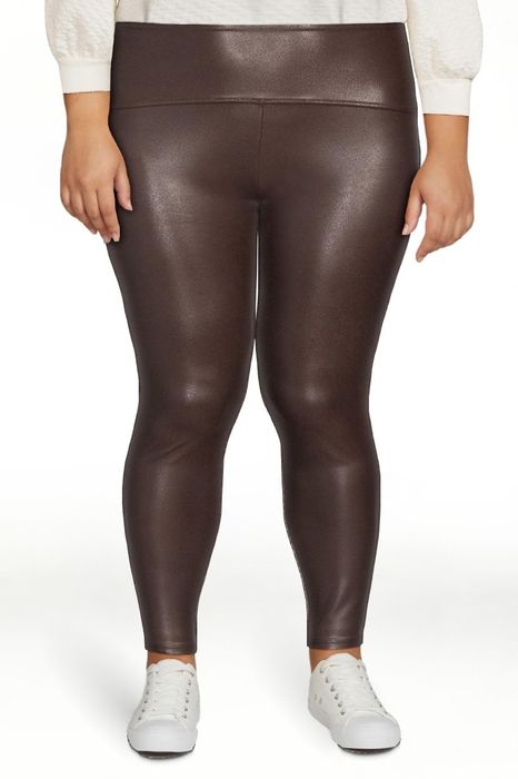 Model wearing brown leggings paired with white sneakers