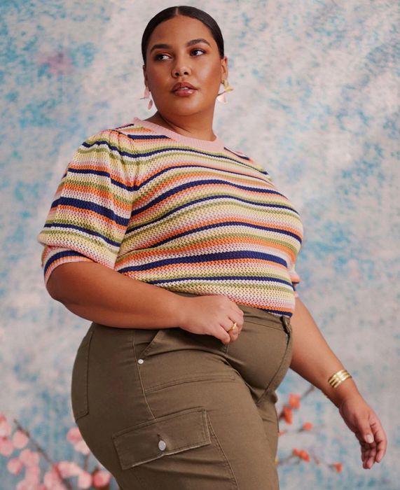 Model wearing a striped puff-sleeve sweater
