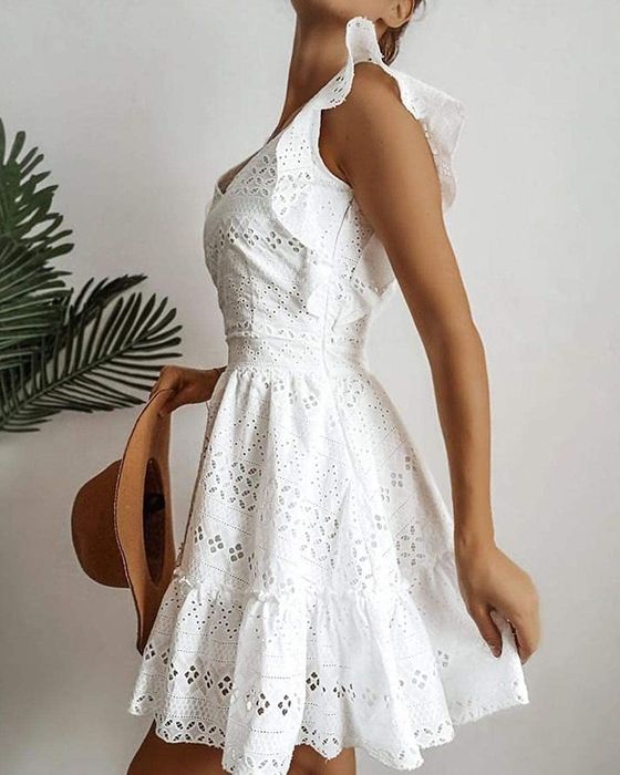 A model wearing the dress in a crisp white color.