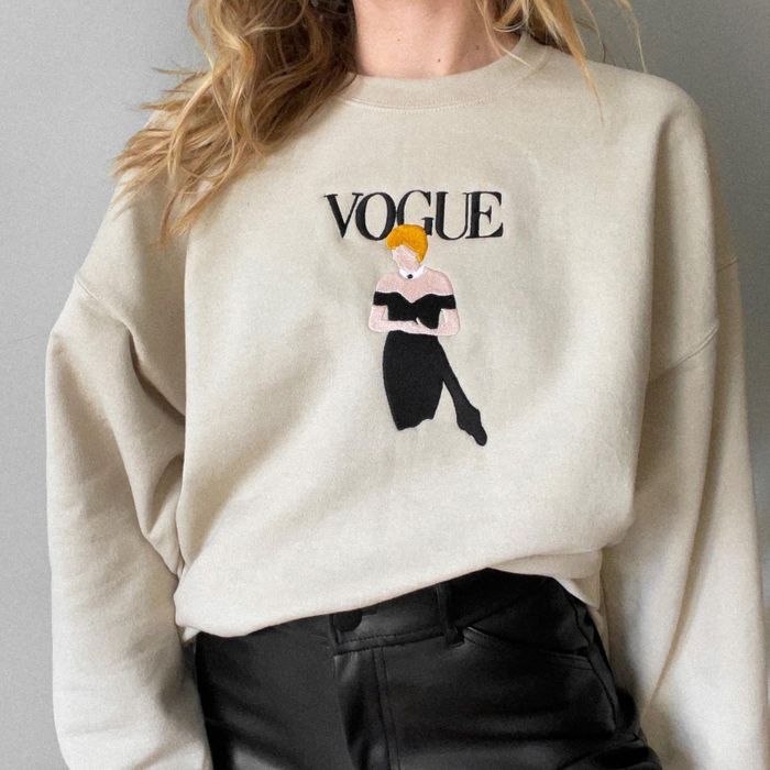 The beige sweatshirt with an embroidered depiction of Princess Diana in a strapless black dress on the front and the word 