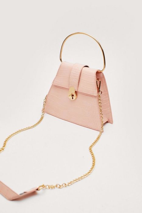 Side view of the pink handbag.
