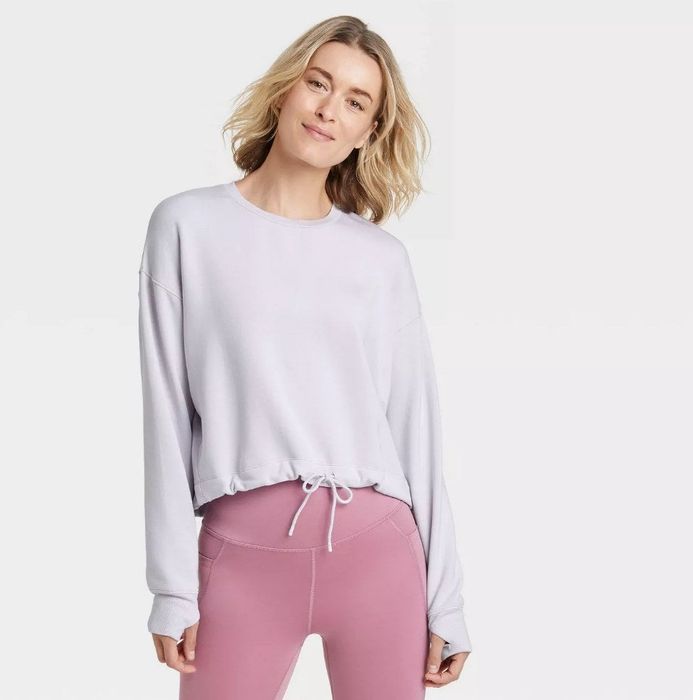 A model sporting the same soft fleece crewneck pullover sweatshirt in a frosty lavender hue