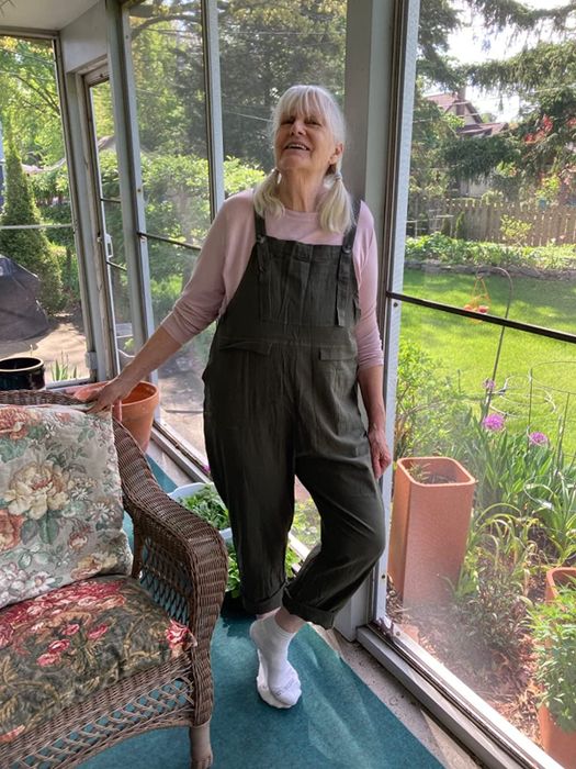 A reviewer modeling the green overalls