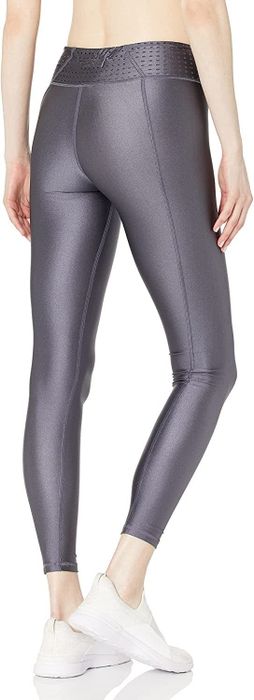 A model wearing the sleek gray version of the leggings