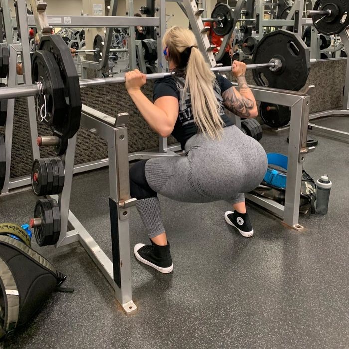 A reviewer performing a squat while bench pressing