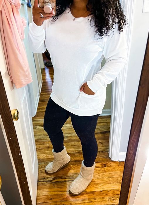 a reviewer modeling the white version of the shirt