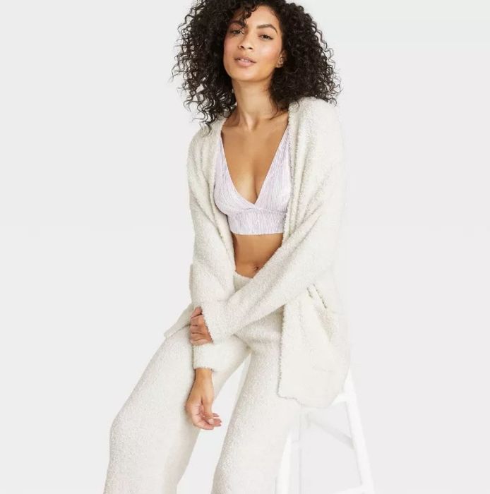 A model wearing the white fuzzy cardigan