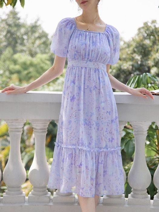 A model wearing a purple cap sleeve dress