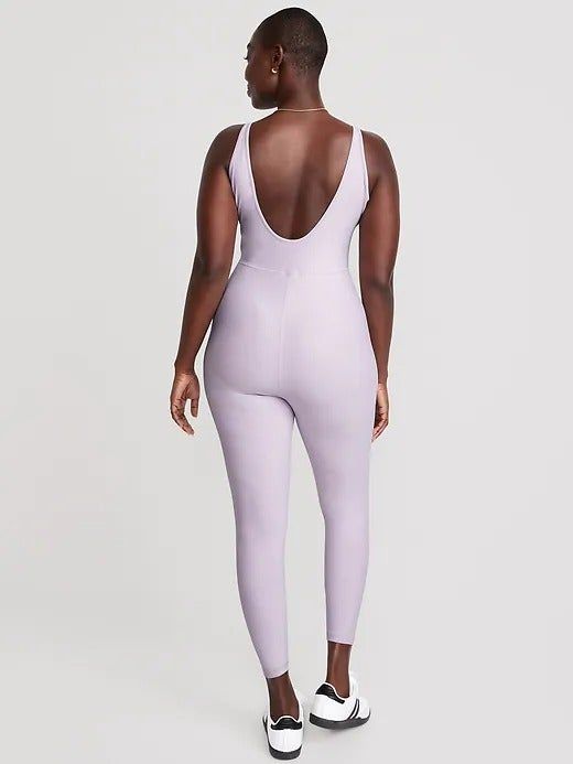 model showcasing the deep U-shaped back of the bodysuit