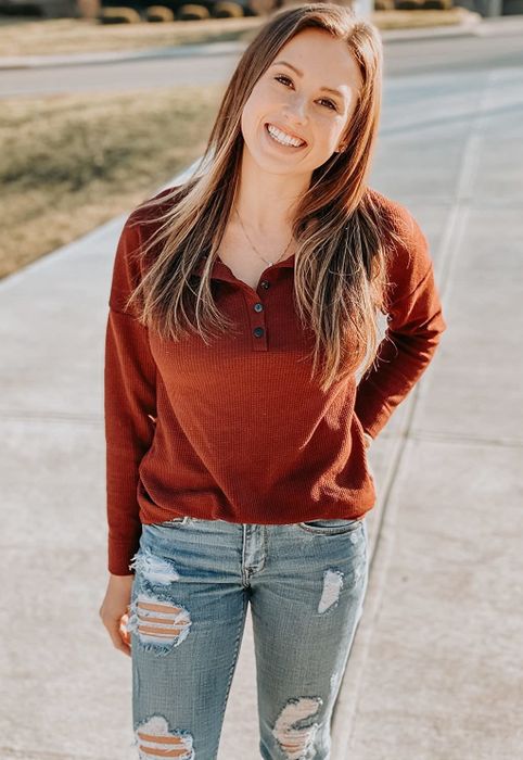Reviewer wearing the red henley shirt with jeans