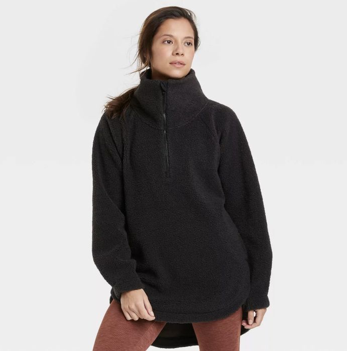 A model wearing the black longline sherpa sweatshirt paired with rust-colored leggings