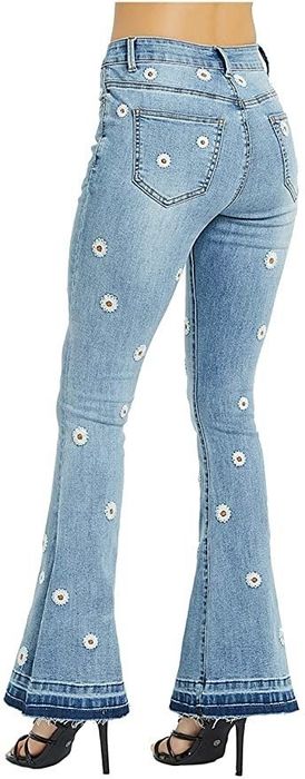 A model wearing the jeans and posing to show them from the back.
