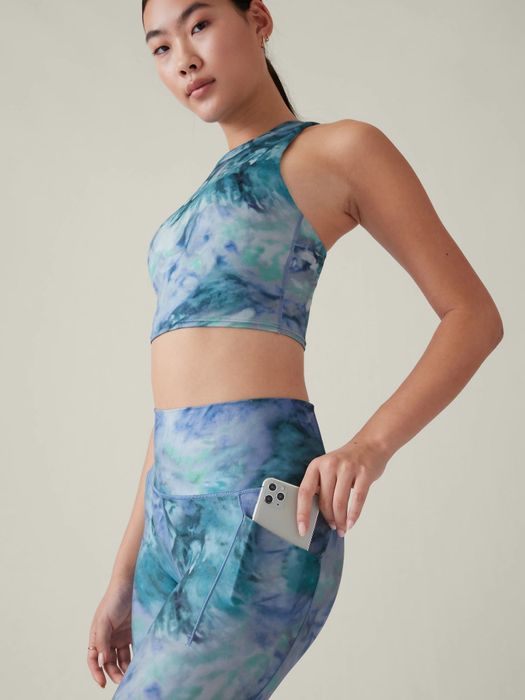 model demonstrating the side pocket’s fit with an iPhone