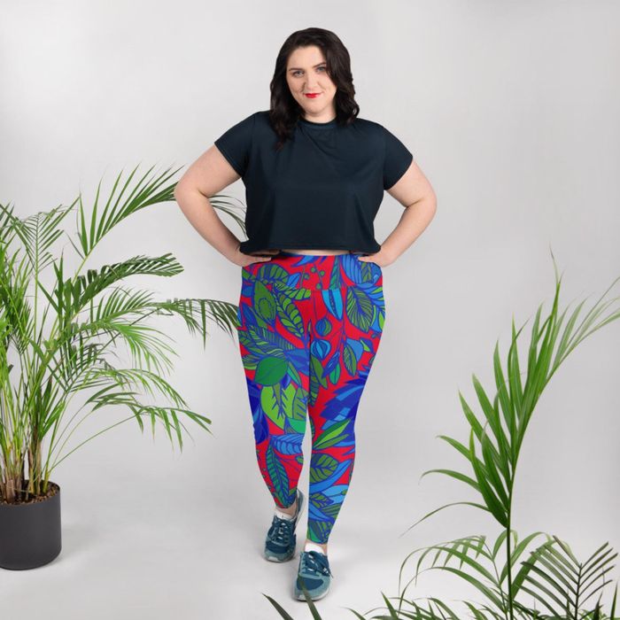 A plus-size model showcases the red Lala Plus Size leggings paired with a black crop top