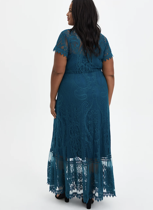 A model highlighting the back view of the dress.