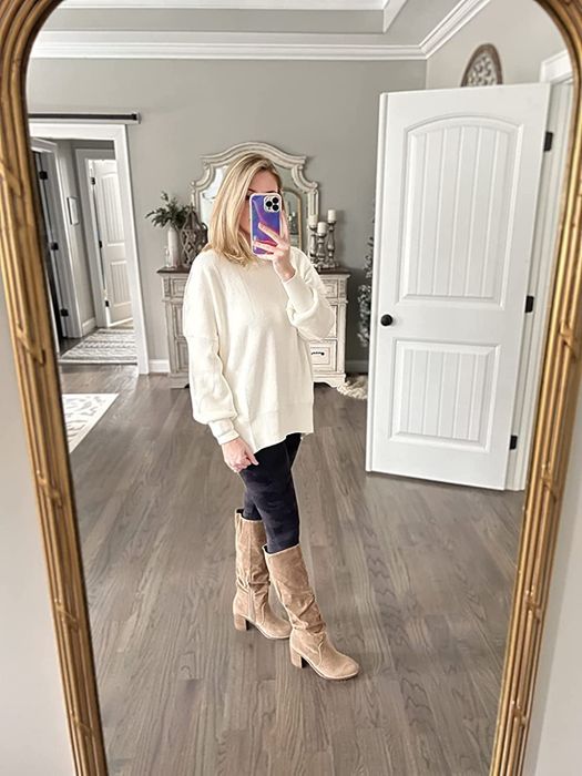 reviewer wearing the white sweater