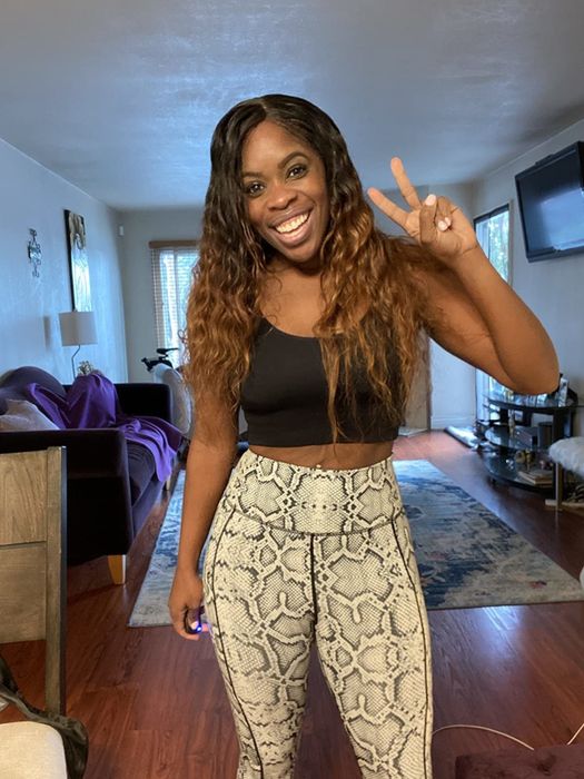 A reviewer showcasing gray snake-print leggings