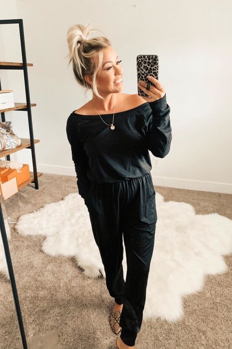 a second photo of another reviewer wearing the black jumpsuit with mules