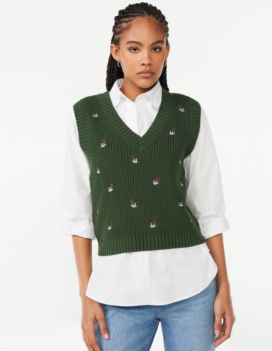 Model showcasing an embroidered sweater vest