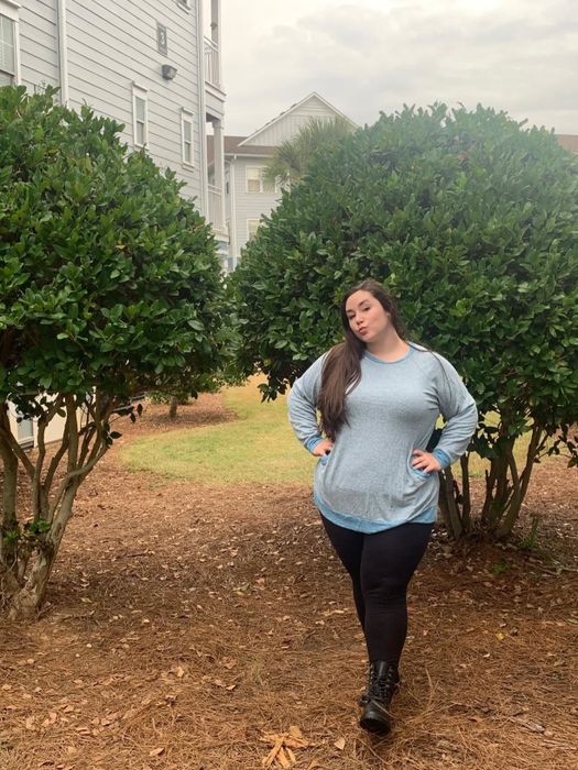 a reviewer modeling the light blue sweater