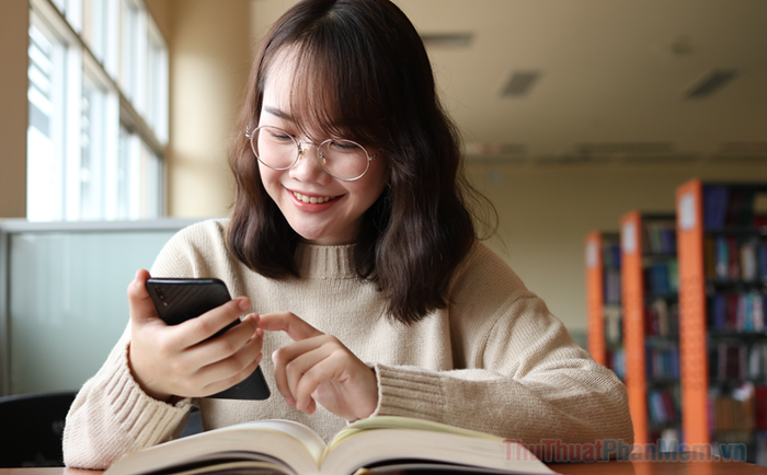 A reviewer showcasing denim overalls