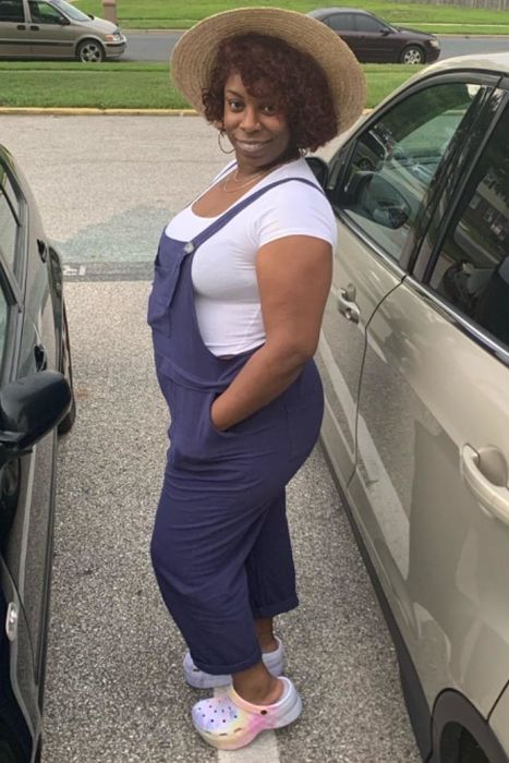 A reviewer modeling blue overalls