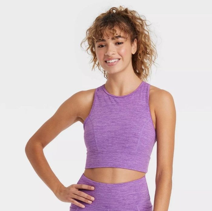 A model showcasing an amethyst space-dye longline sports bra