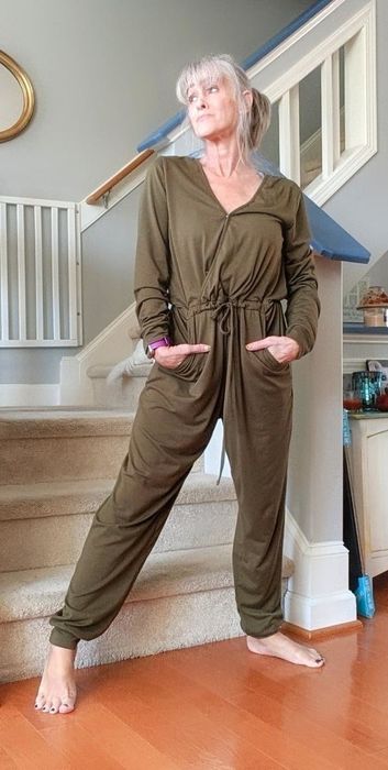 a reviewer modeling the green jumpsuit