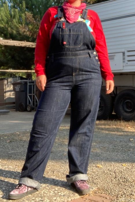 A reviewer wearing denim overalls