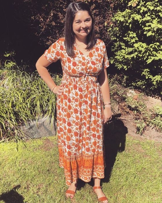 Mytour editor showcasing a floral-patterned orange midi dress with a button-up design