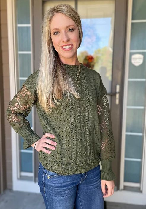 a reviewer wearing the sweater in a green hue