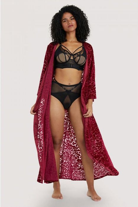 a model wearing the Playful Promises Aubergine Devore Gown, left open