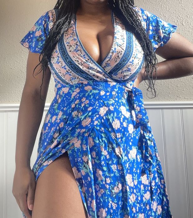 a reviewer modeling the blue wrap dress