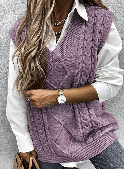 A model is shown wearing a purple cable knit vest layered over a white button-down blouse.