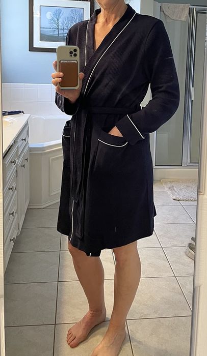 customer image of a reviewer snapping a mirror selfie in the black Amazon Essentials Women's Lightweight Waffle Mid-Length Robe