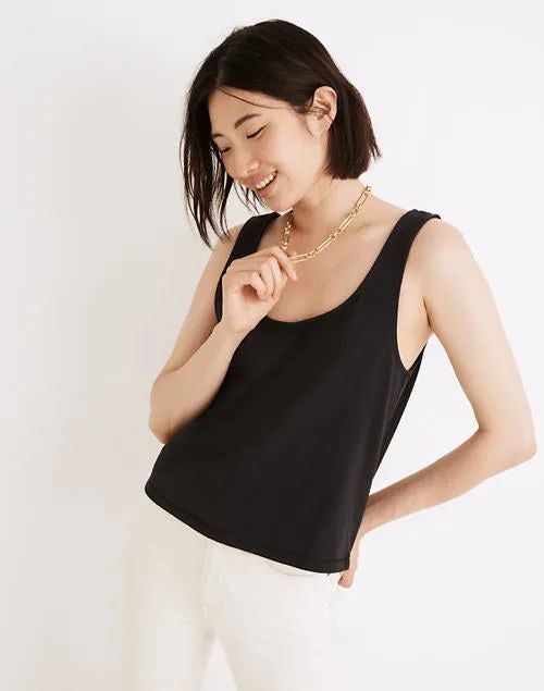 A model styled in a black boxy crop tank top.