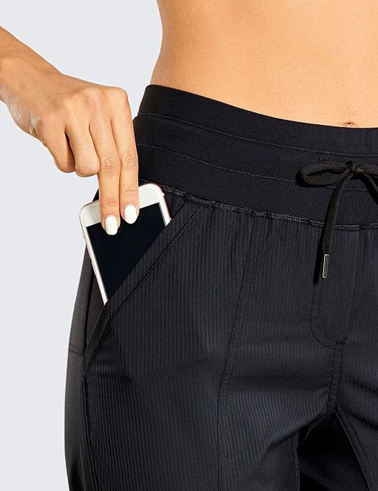 detailed close-up showcasing the pinstripe design and side pocket on the CRZ YOGA Women's Studio Capri Joggers