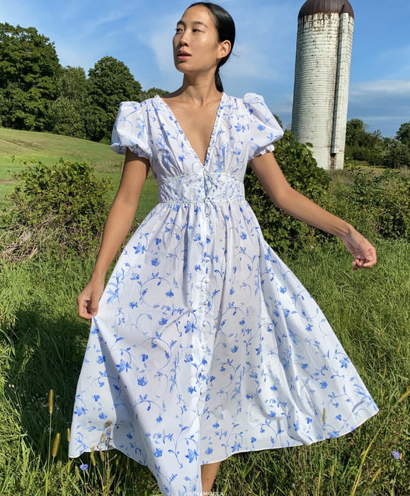 a model strolls through a field wearing the opaque Sabrina Nap Dress