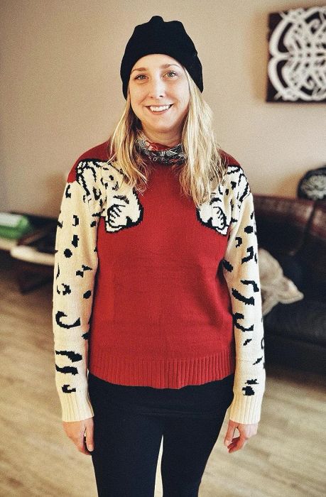 a reviewer wearing the sweater in a warm burnt orange hue