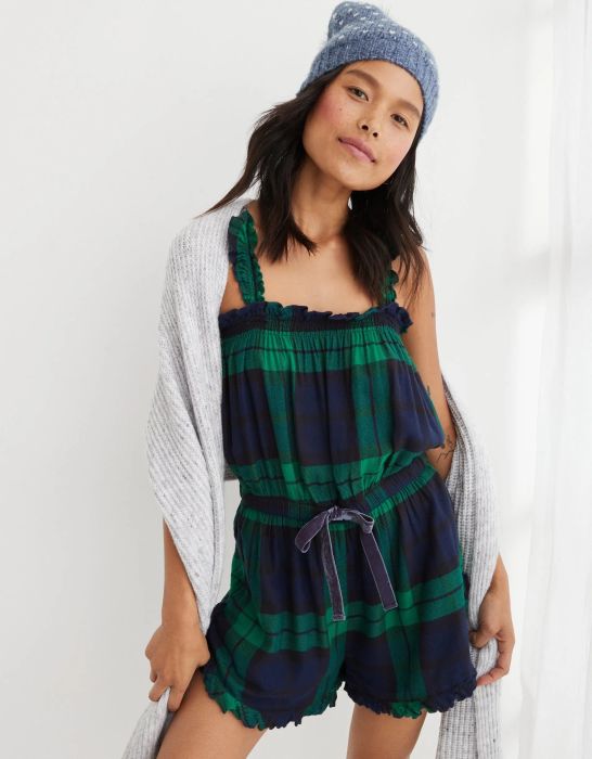 model in a green and blue plaid ruffle-edged short tank top romper with a velvet waist tie