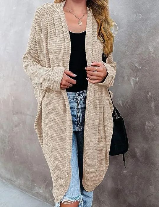 a model showcasing the cardigan in a creamy shade