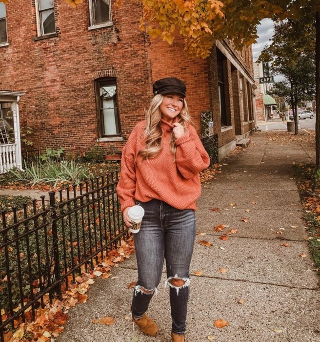 Reviewer wearing an orange sweater with a high turtleneck