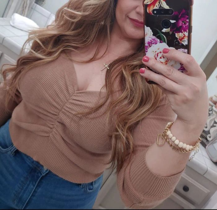 a reviewer modeling the shirt in a soft light brown shade